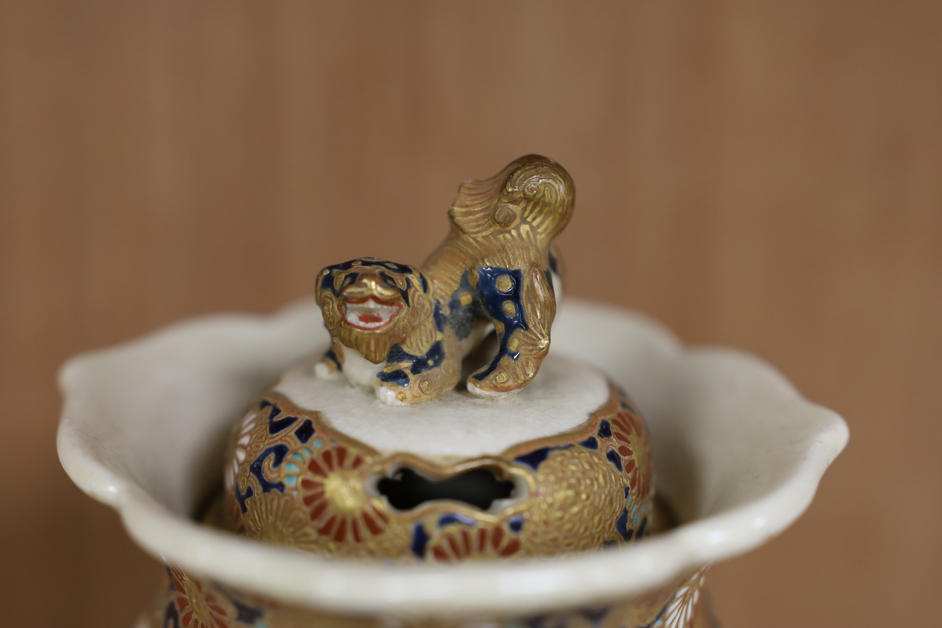 A late 19th century Japanese Satsuma ‘hundred antiques’ gosu blue pot pourri vase and three later items of Satsuma, including a bowl and cover a bowl on stand, a box and cover, tallest 18.5cm high. Condition - vase cover